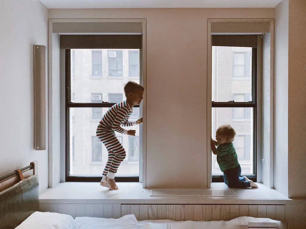 two young boys playing jumping